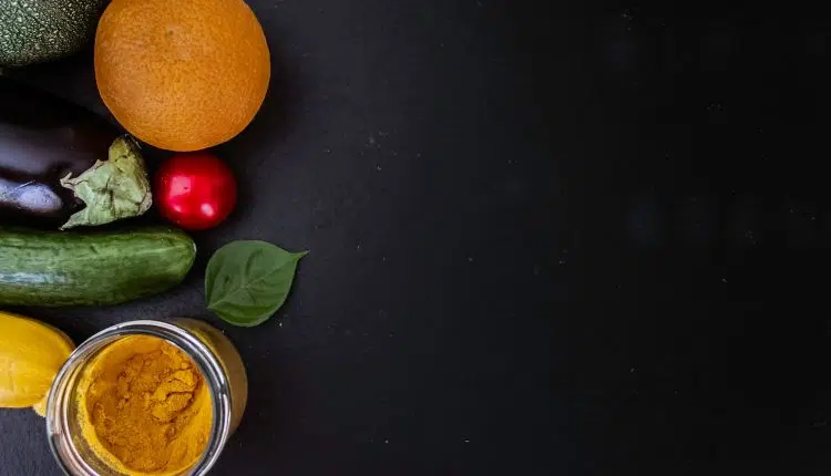 orange fruit beside green round fruit