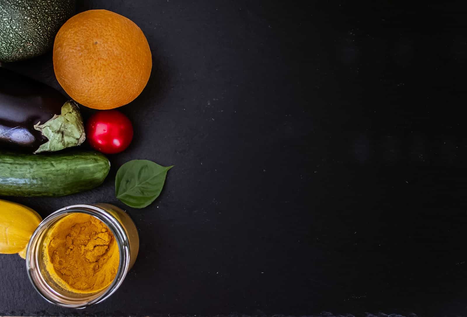 orange fruit beside green round fruit